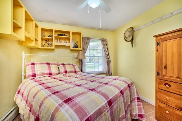 10 Phillips Dr, Colrain, MA 01340 - bedroom with a baseboard heating unit, wood finished floors, baseboards, and ceiling fan