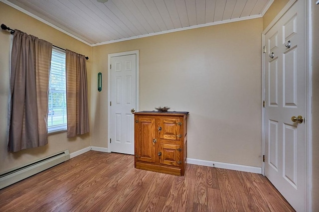 10 Phillips Dr, Colrain, MA 01340 - unfurnished room with crown molding, baseboard heating, baseboards, and light wood-type flooring