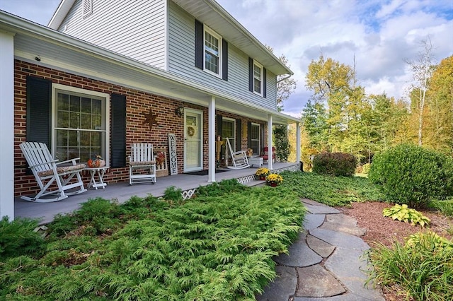 10 Phillips Dr, Colrain, MA 01340 - back of property with a porch and brick siding