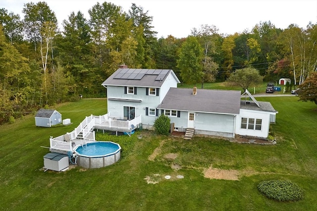 10 Phillips Dr, Colrain, MA 01340 - back of house with a wooden deck, an outdoor pool, a yard, and a view of trees
