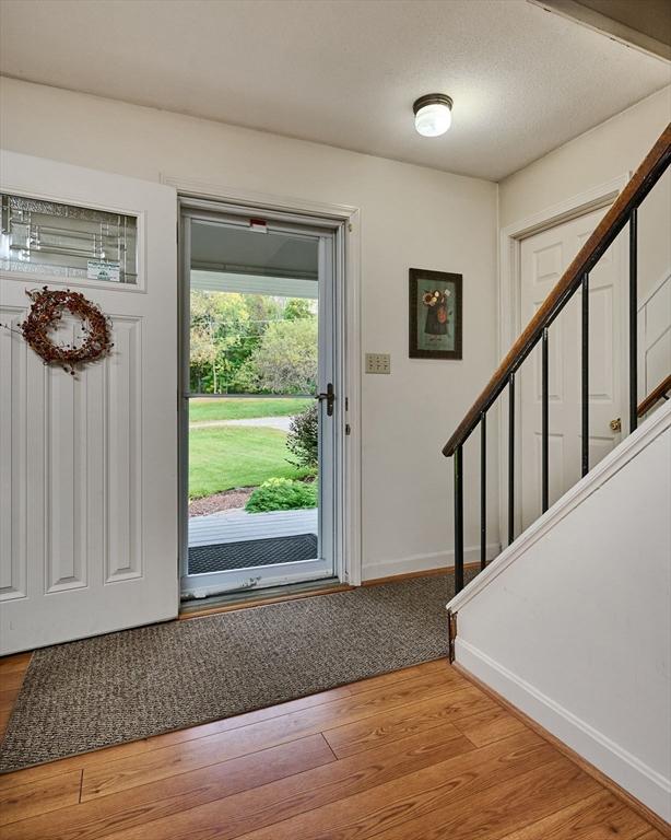 10 Phillips Dr, Colrain, MA 01340 - entrance foyer featuring stairs, light wood finished floors, and baseboards
