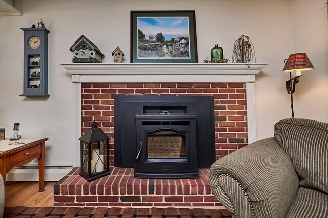 10 Phillips Dr, Colrain, MA 01340 - detailed view of baseboard heating, wood finished floors, and a brick fireplace