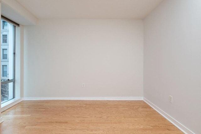 unfurnished room with light wood-style floors and baseboards