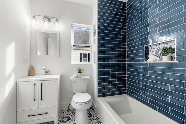 bathroom featuring tile patterned flooring, a tile shower, vanity, and toilet