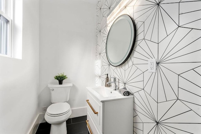 bathroom featuring tile patterned floors, vanity, and toilet