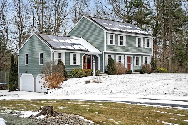 view of front of home with solar panels and a garage