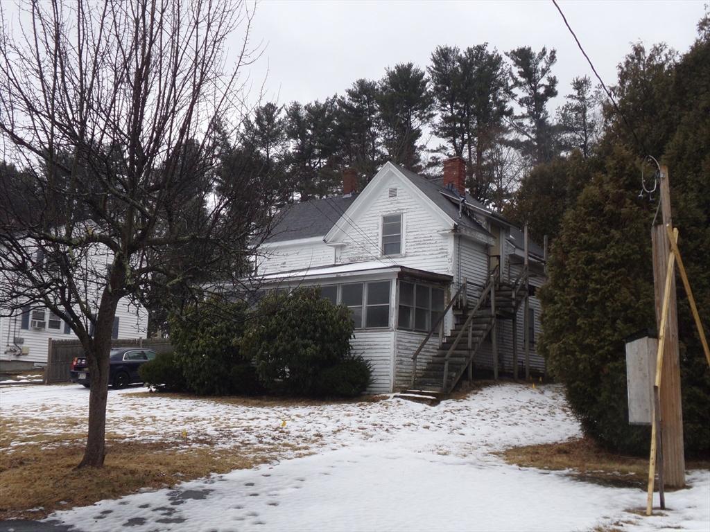 view of snow covered exterior with a sunroom