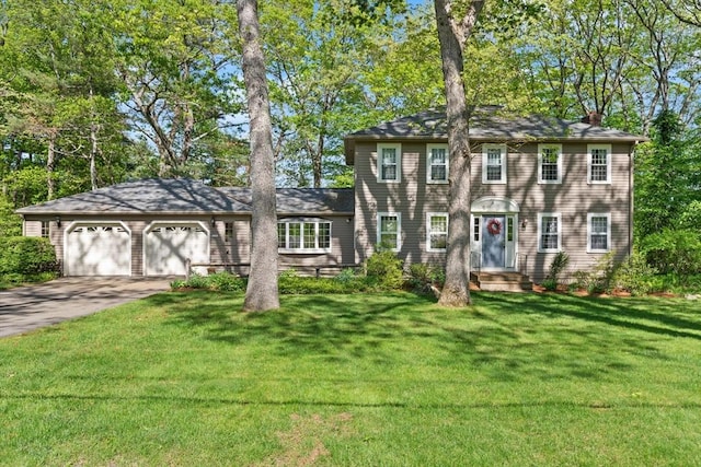 18 Sylvan Way, Sudbury, MA 01776 - colonial house with concrete driveway, a chimney, a garage, and a front lawn