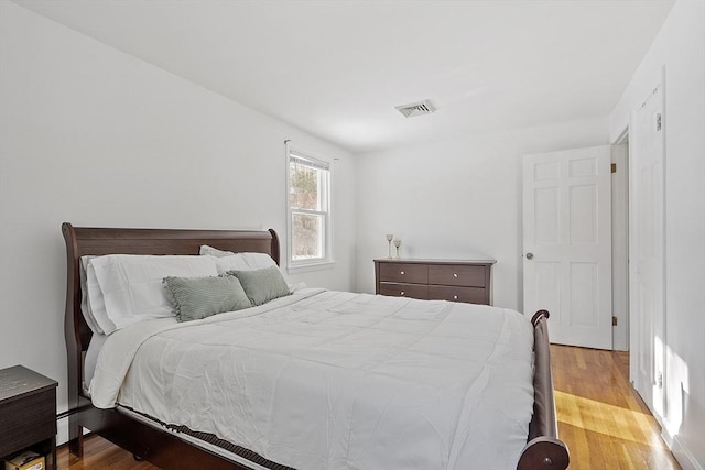 bedroom featuring baseboard heating and light wood-type flooring