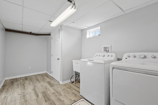 laundry area featuring light hardwood / wood-style flooring and washer and clothes dryer