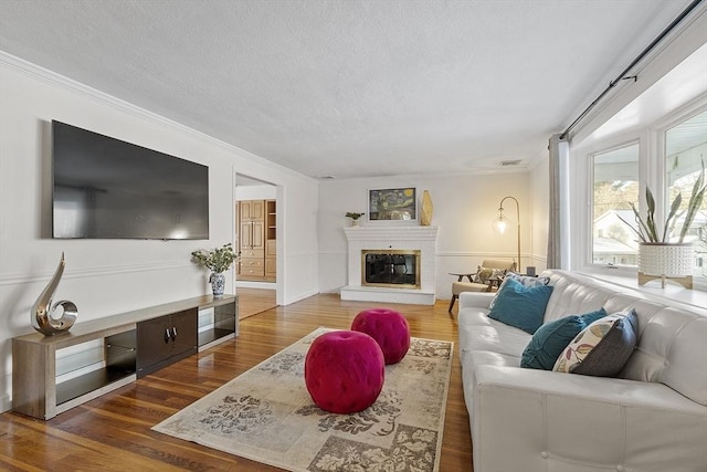 living room with crown molding and dark hardwood / wood-style floors