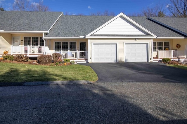 ranch-style home featuring a garage, a porch, a shingled roof, and aphalt driveway