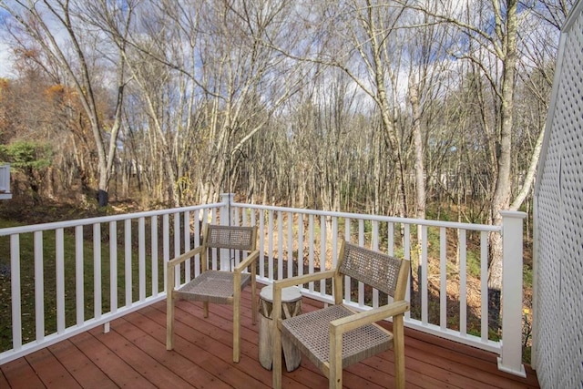 wooden terrace featuring a forest view