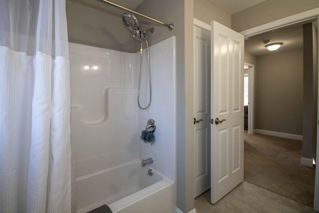 bathroom with baseboards, shower / bath combination with curtain, and tile patterned floors