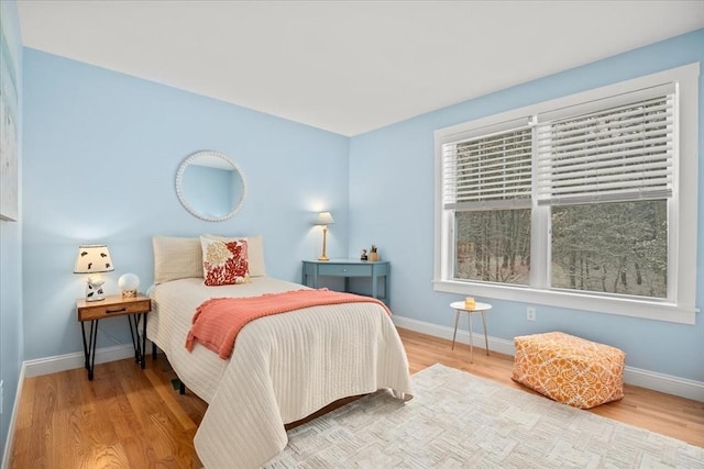 bedroom with wood finished floors and baseboards