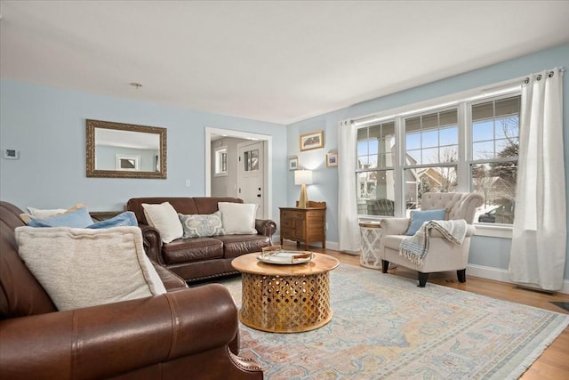 living room featuring baseboards and light wood finished floors