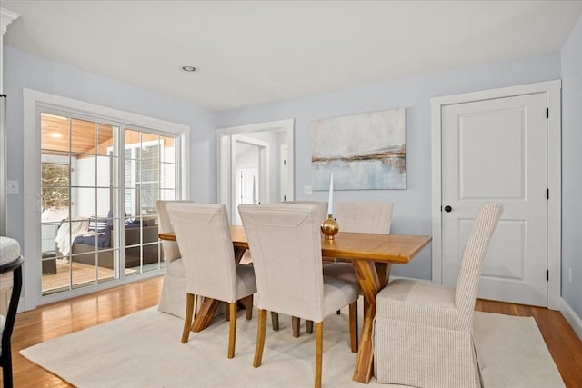 dining area with light wood-type flooring and recessed lighting