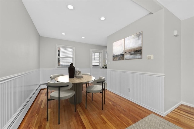 dining room featuring baseboard heating and hardwood / wood-style floors