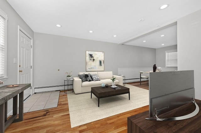 living room with light wood-type flooring and a baseboard radiator