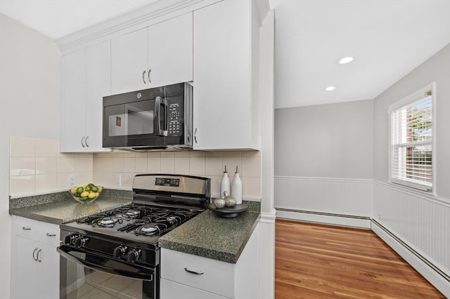 kitchen with baseboard heating, white cabinets, and black appliances