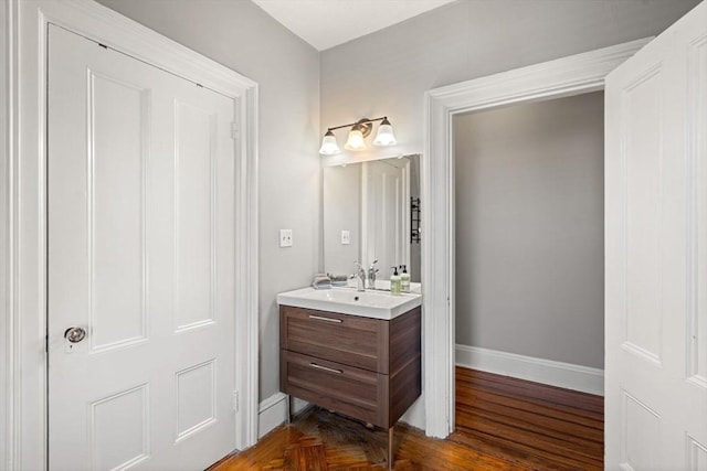 bathroom with vanity and parquet flooring