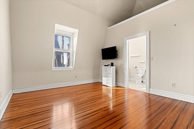 interior space with vaulted ceiling and wood-type flooring