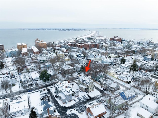 snowy aerial view featuring a water view