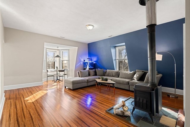 living room featuring a wood stove and hardwood / wood-style floors