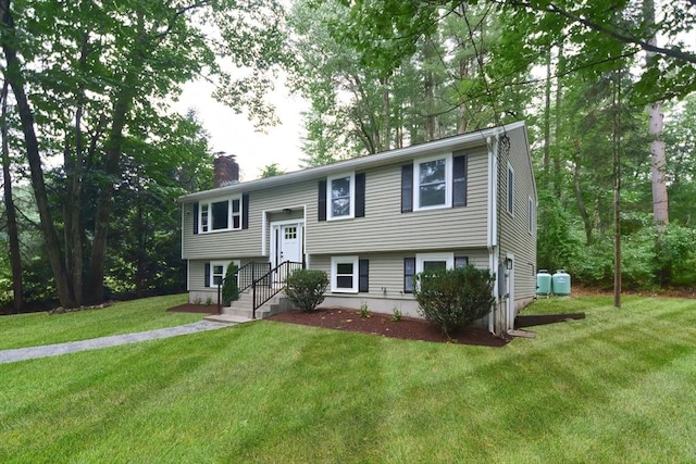 bi-level home with a front lawn