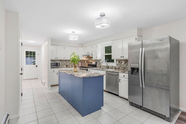 3 Sinclair St, Billerica, MA 01821 - kitchen with appliances with stainless steel finishes, tasteful backsplash, white cabinets, a kitchen island, and light stone countertops