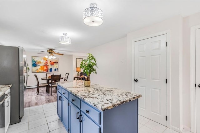 3 Sinclair St, Billerica, MA 01821 - kitchen with blue cabinetry, a ceiling fan, light tile patterned flooring, a kitchen island, and freestanding refrigerator