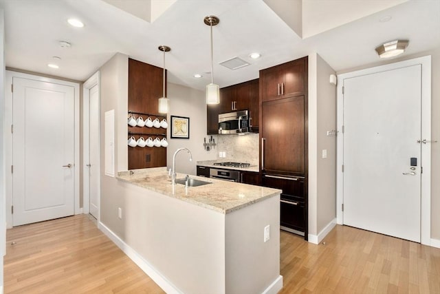 400 Stuart St Unit 15G, Boston, MA 02116 - kitchen with appliances with stainless steel finishes, a sink, light wood-style floors, baseboards, and recessed lighting