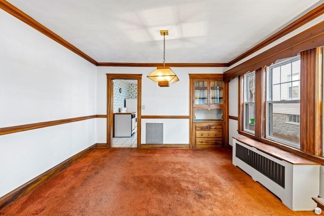 unfurnished dining area with crown molding, radiator, and light carpet