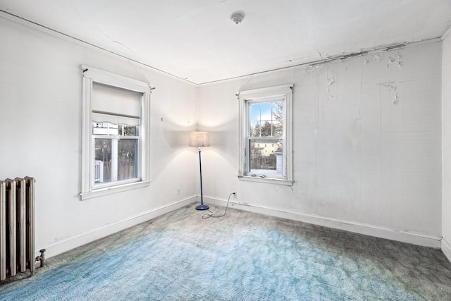 carpeted empty room featuring radiator