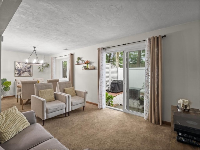 49 Meadow Pond Dr Unit I, Leominster, MA 01453 - carpeted living area with a chandelier, plenty of natural light, and a textured ceiling