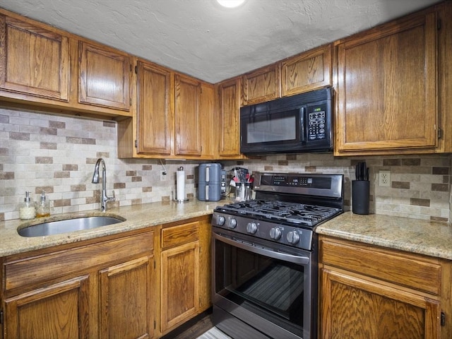 49 Meadow Pond Dr Unit I, Leominster, MA 01453 - kitchen with stainless steel gas stove, black microwave, decorative backsplash, brown cabinetry, and light stone counters