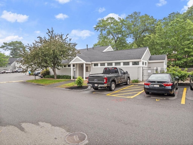 49 Meadow Pond Dr Unit I, Leominster, MA 01453 - view of front facade with uncovered parking and a shingled roof