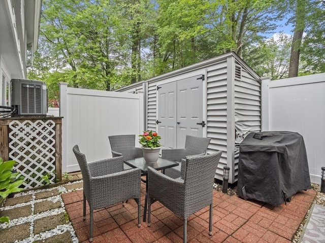 49 Meadow Pond Dr Unit I, Leominster, MA 01453 - view of patio / terrace with a storage unit, outdoor dining area, and a grill