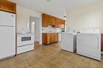 washroom with independent washer and dryer, laundry area, and a sink