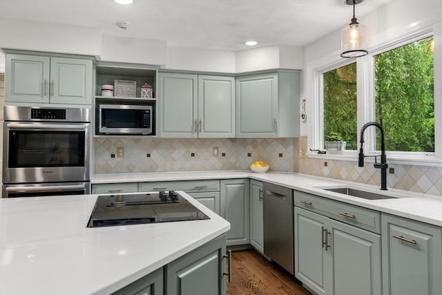 27 Bowker Dr, Sudbury, MA 01776 - kitchen featuring a sink, stainless steel appliances, light countertops, gray cabinets, and decorative light fixtures
