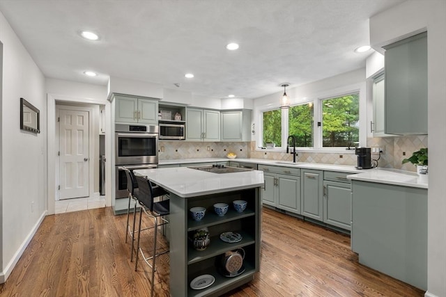27 Bowker Dr, Sudbury, MA 01776 - kitchen with open shelves, appliances with stainless steel finishes, a sink, a kitchen island, and decorative backsplash