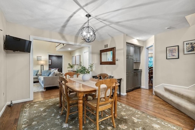 27 Bowker Dr, Sudbury, MA 01776 - dining space featuring wood finished floors, baseboards, and a chandelier