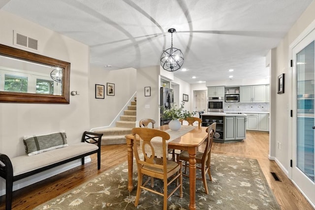 27 Bowker Dr, Sudbury, MA 01776 - dining area with light wood-style flooring, stairway, recessed lighting, a chandelier, and baseboards