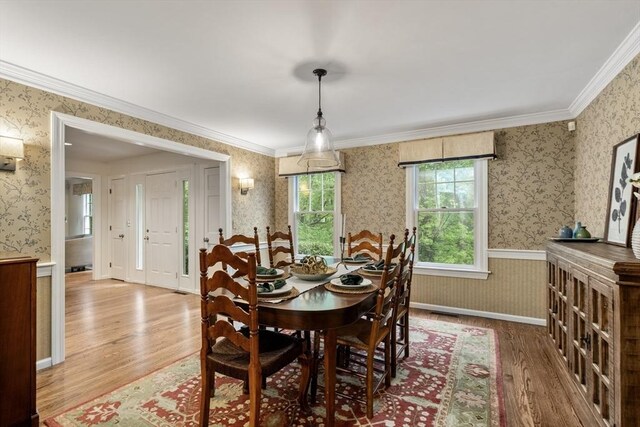 27 Bowker Dr, Sudbury, MA 01776 - dining space featuring wood finished floors, wallpapered walls, and crown molding