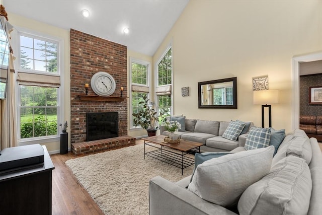 27 Bowker Dr, Sudbury, MA 01776 - living room with high vaulted ceiling, a fireplace, wood finished floors, and recessed lighting