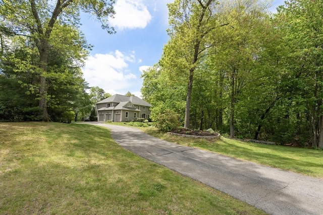 27 Bowker Dr, Sudbury, MA 01776 - view of front of home with asphalt driveway, a front yard, and a garage