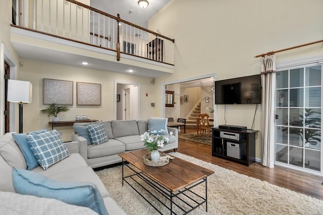 27 Bowker Dr, Sudbury, MA 01776 - living area with stairs, wood finished floors, and a towering ceiling