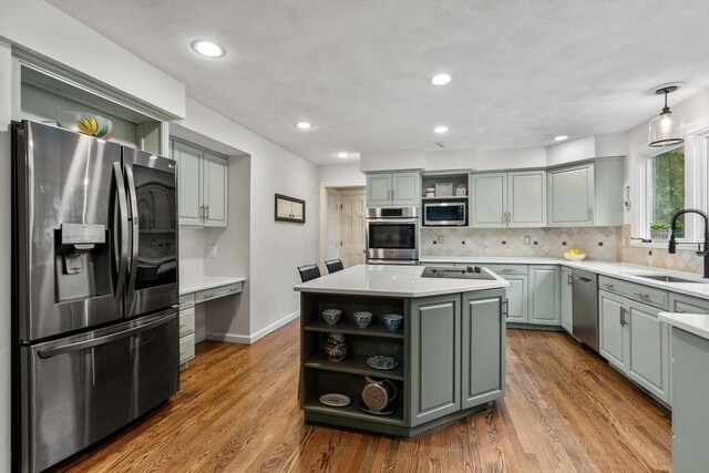 27 Bowker Dr, Sudbury, MA 01776 - kitchen with open shelves, stainless steel appliances, a sink, a center island, and backsplash