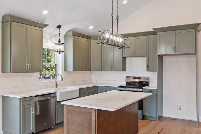 kitchen featuring light wood-style flooring, an inviting chandelier, appliances with stainless steel finishes, and a sink