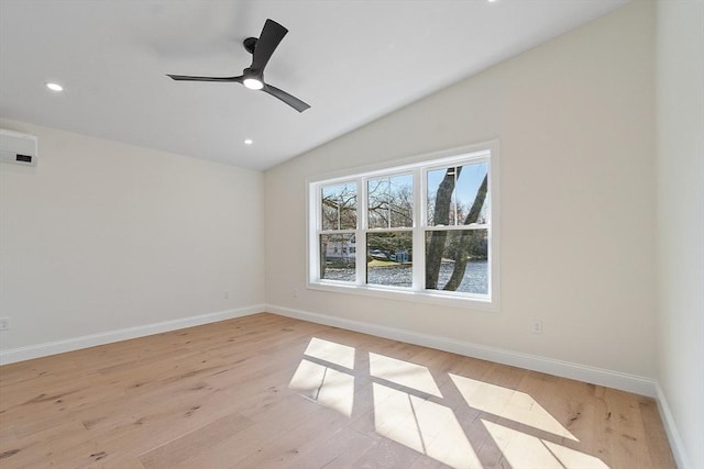 spare room featuring lofted ceiling, light wood-style floors, recessed lighting, and baseboards